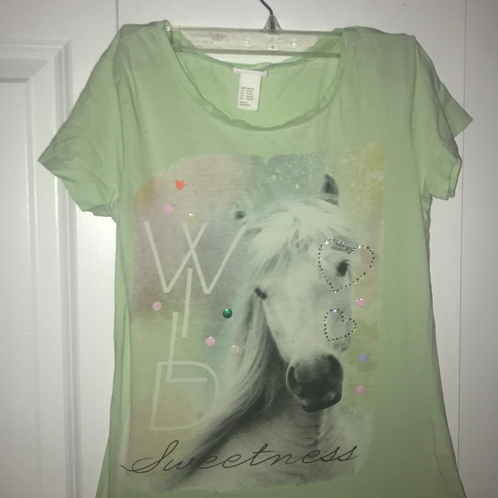 A mint colored tee with an image including sequins